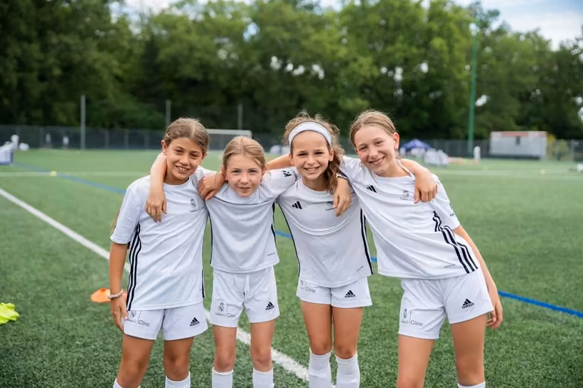Young players enjoying a Fundación Real Madrid soccer camp experience